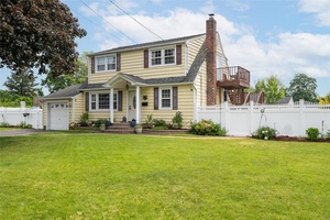 Welcome to this spacious and beautifully maintained Expanded Cape, ideally situated mid block in a quiet Brightwaters Farms neighborhood.