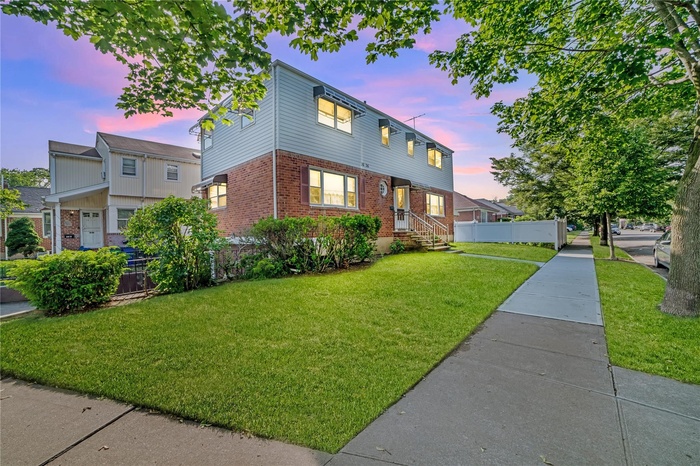 View of front of home featuring brick siding