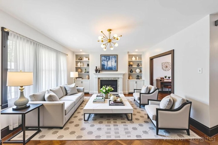 Living area with a chandelier, built in shelves, and a fireplace