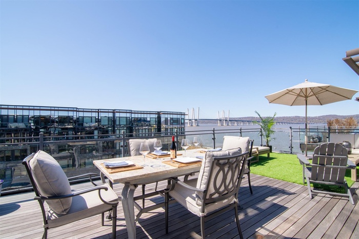 Deck featuring a water view and outdoor dining space