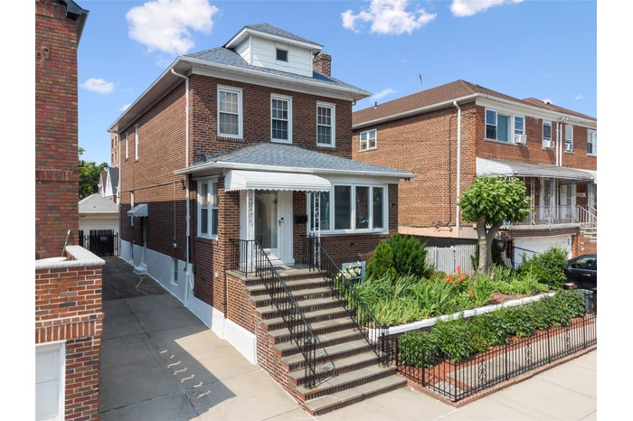 Traditional style home featuring brick siding and roof with shingles