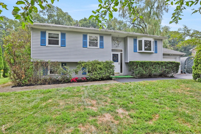 Raised ranch featuring a front lawn