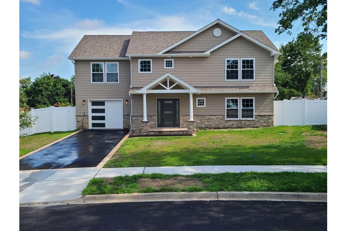 Craftsman-style house with stone siding, asphalt driveway, a garage, and a shingled roof