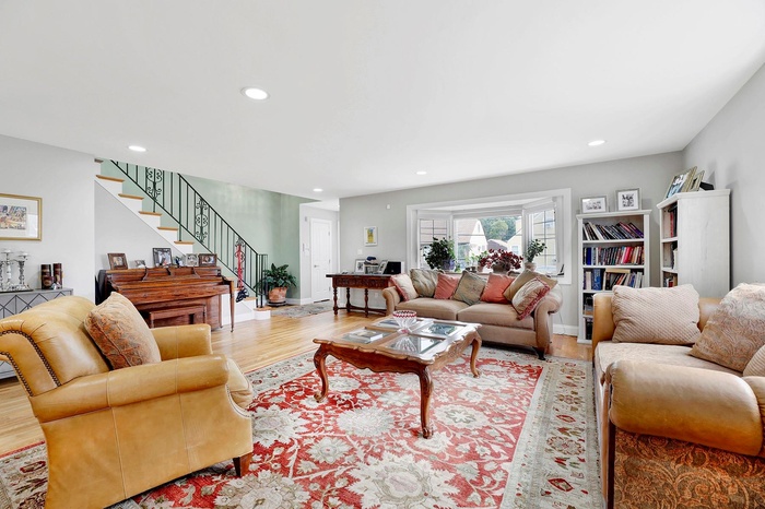 Living room featuring stairway, recessed lighting, and wood finished floors