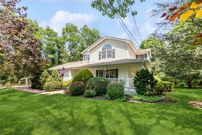 View of home's exterior with a yard and covered porch