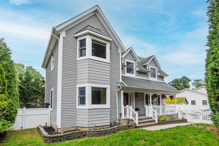 View of front of home featuring a porch and a shingled roof