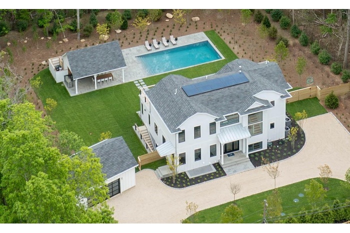 Aerial view of house, pool house, pool, yard & garage