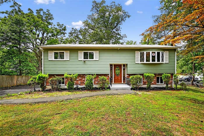 Raised ranch featuring brick siding