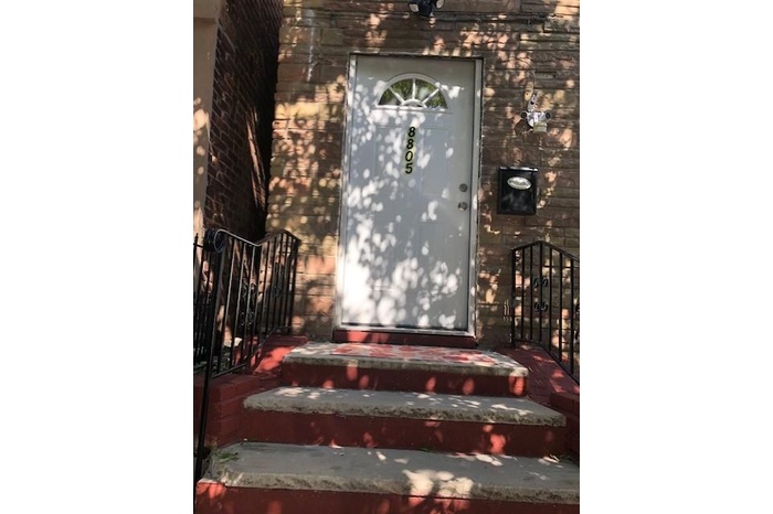 Doorway to property with brick siding