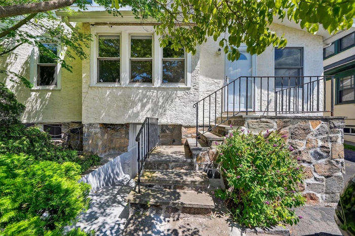 View of exterior entry with stucco siding