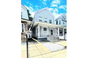 Welcome to 97 12 110th Street, a classic two story single family home that blends timeless charm with unbeatable convenience.