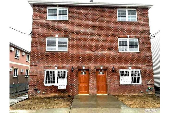 View of front of property with brick siding
