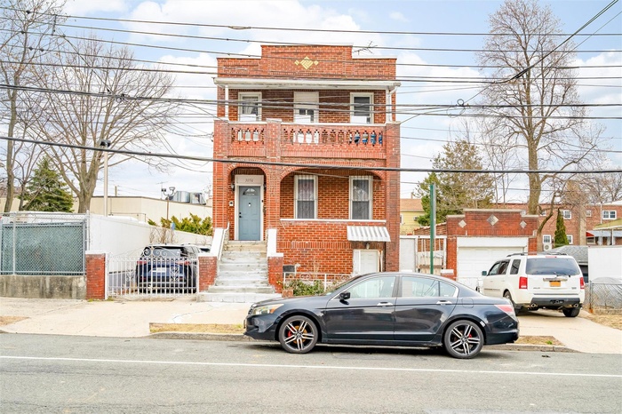 View of property with brick siding
