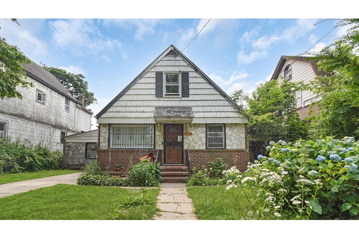 View of front of house featuring brick siding and a front lawn