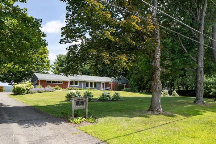 Single story home featuring a front lawn and brick siding