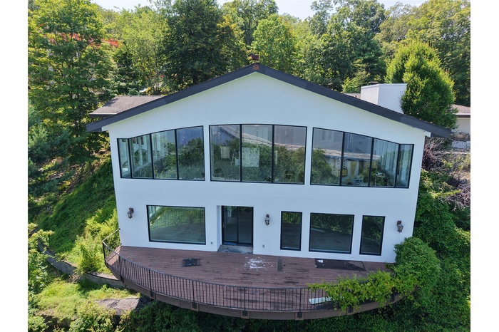 Modern home with stucco siding and a deck