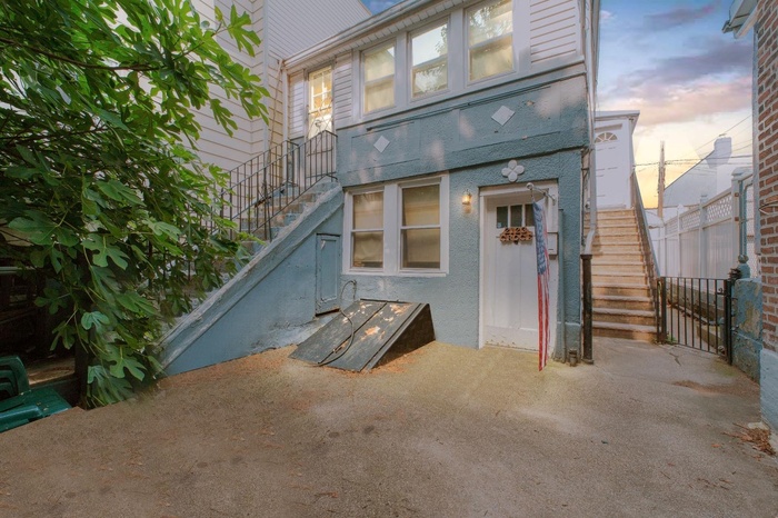 Back of property featuring stairway and stucco siding