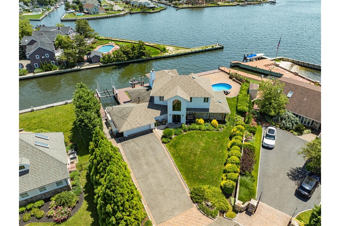 Aerial perspective of suburban area featuring a large body of water