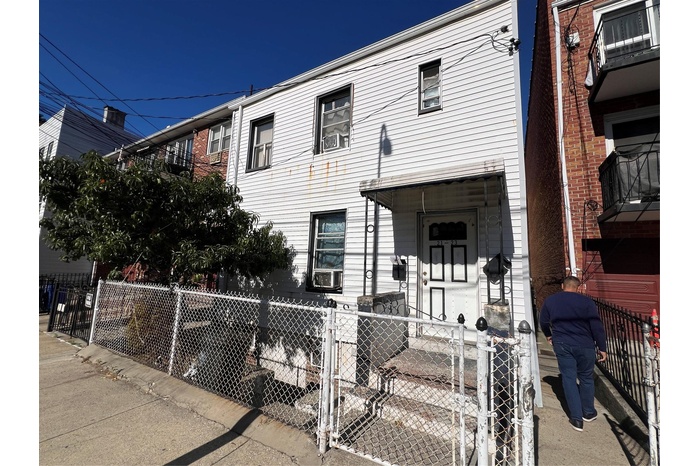 View of property with a fenced front yard and cooling unit