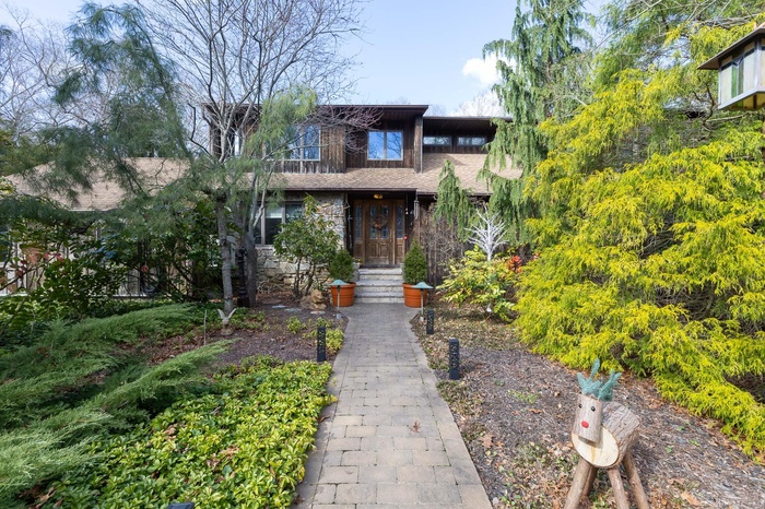 View of front of property with a shingled roof