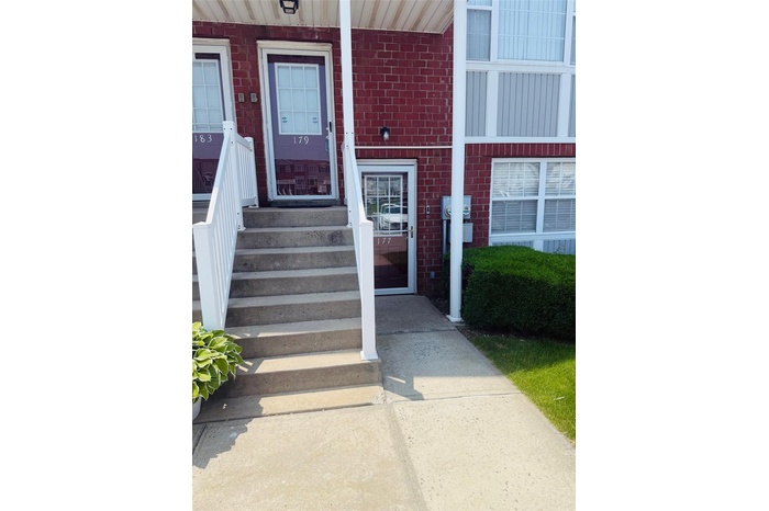 View of exterior entry featuring brick siding
