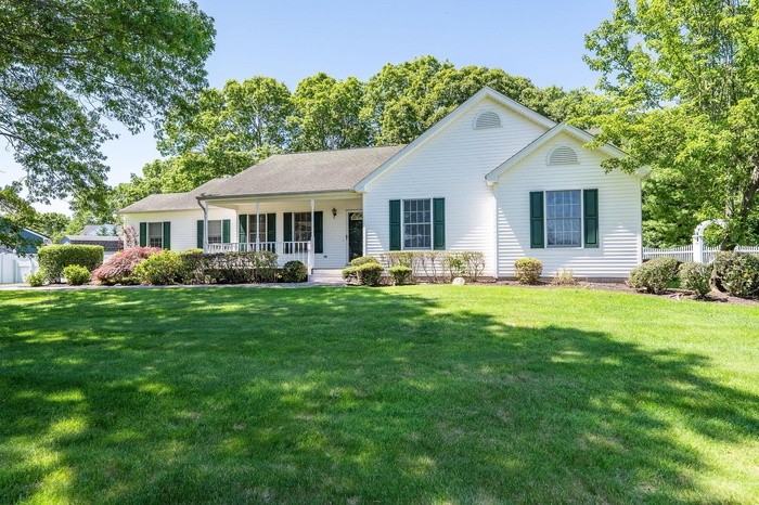 Ranch-style house with a porch and a front lawn