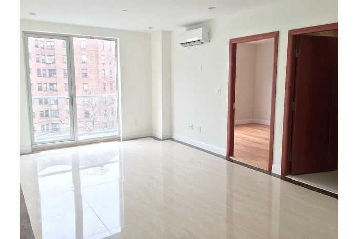 Spare room with baseboards, a wall mounted AC, and tile patterned floors