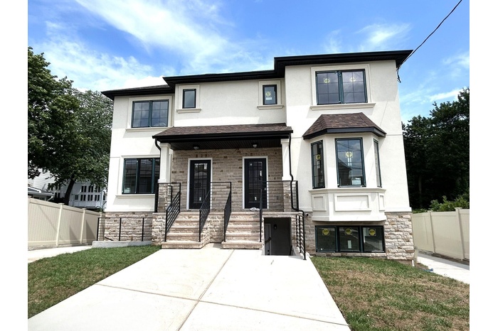 View of front of property featuring stucco siding, stone siding, and a shingled roof