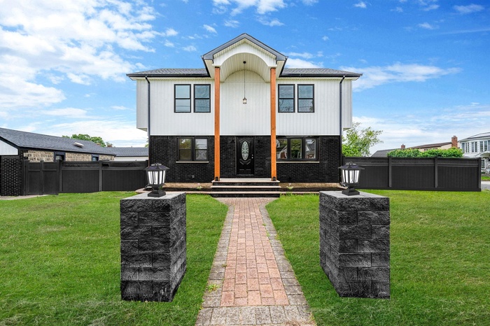 View of front of house featuring brick siding