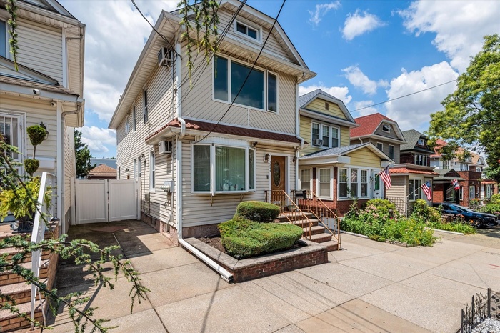 American foursquare style home featuring a gate