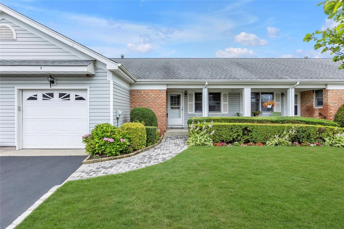 Single story home with roof with shingles and brick siding
