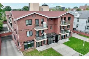 Southward facing 2 bedroom condo with parking in prime Bayside location !