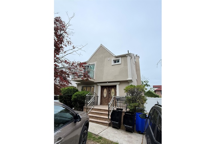 Multi unit property featuring a balcony and stucco siding