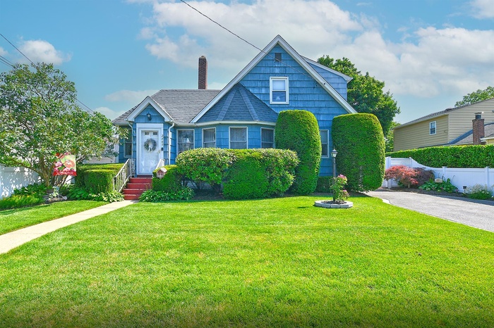 Bungalow-style house featuring a chimney