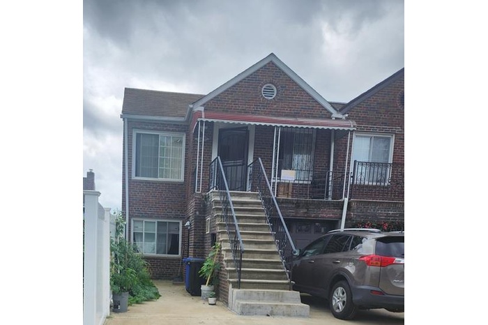 View of front of house featuring brick siding, covered porch, and stairway
