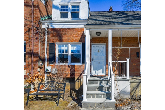 Property entrance with brick siding and roof with shingles