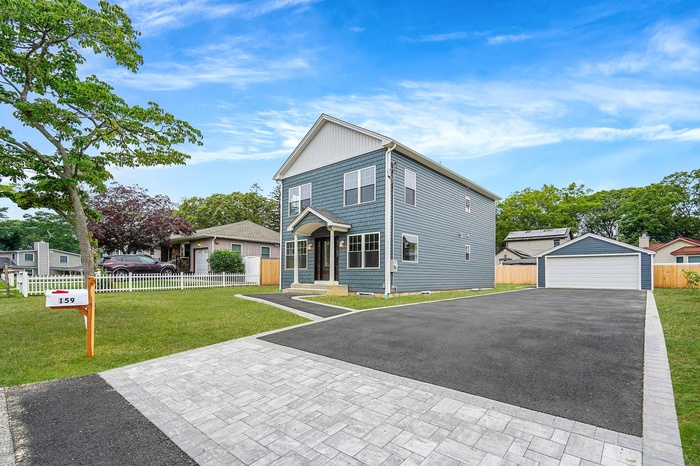 View of front and a detached garage
