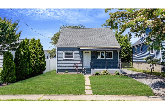 Bungalow-style home with a shingled roof and covered porch