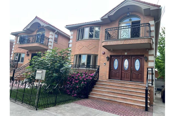 Victorian house featuring a balcony, brick siding, and entry steps
