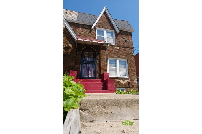 Property entrance featuring brick siding