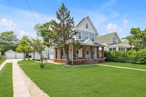 This is a charming two family home on a leafy, oversized lot.