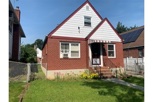 Beautifully maintained full brick Cape style home with a detached garage and private driveway.