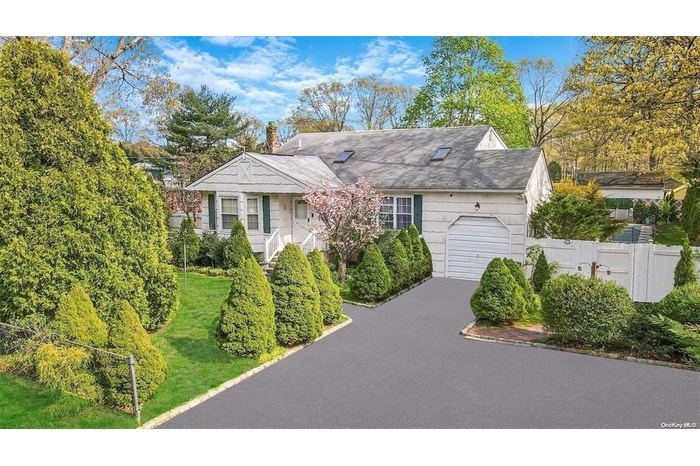 View of front of house with an attached garage and driveway
