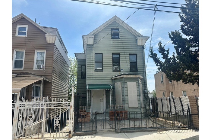 View of front of house with a gate, a fenced front yard, and cooling unit