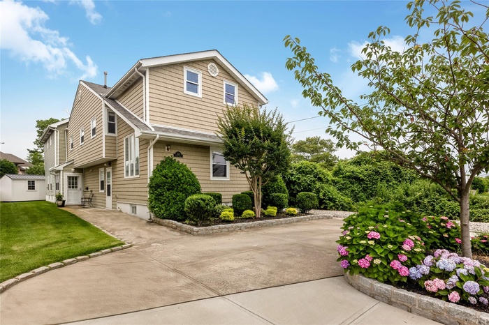 View of front of property exterior featuring a circular driveway