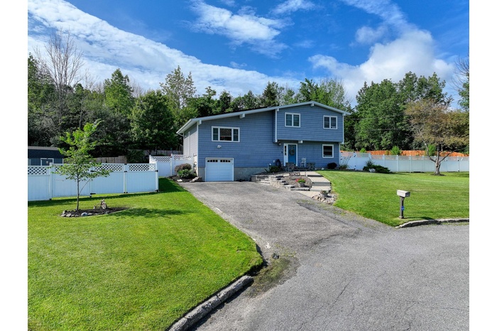 View of front facade featuring an attached garage and driveway