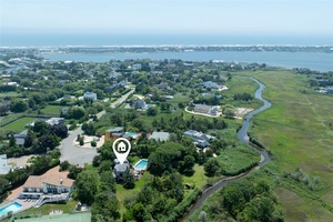 Nestled at the end of a quiet cul de sac with direct water access, this contemporary shingle style home offers privacy, natural beauty, and seamless indoor outdoor living.