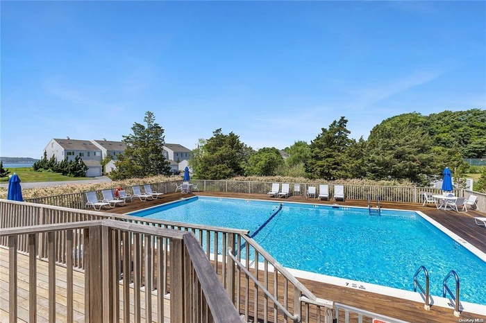 Community pool featuring a wooden deck
