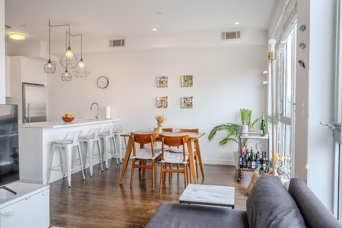Dining space with dark wood-style flooring and recessed lighting