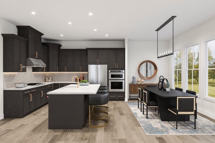 Kitchen featuring under cabinet range hood, stainless steel appliances, light countertops, decorative backsplash, and an island with sink